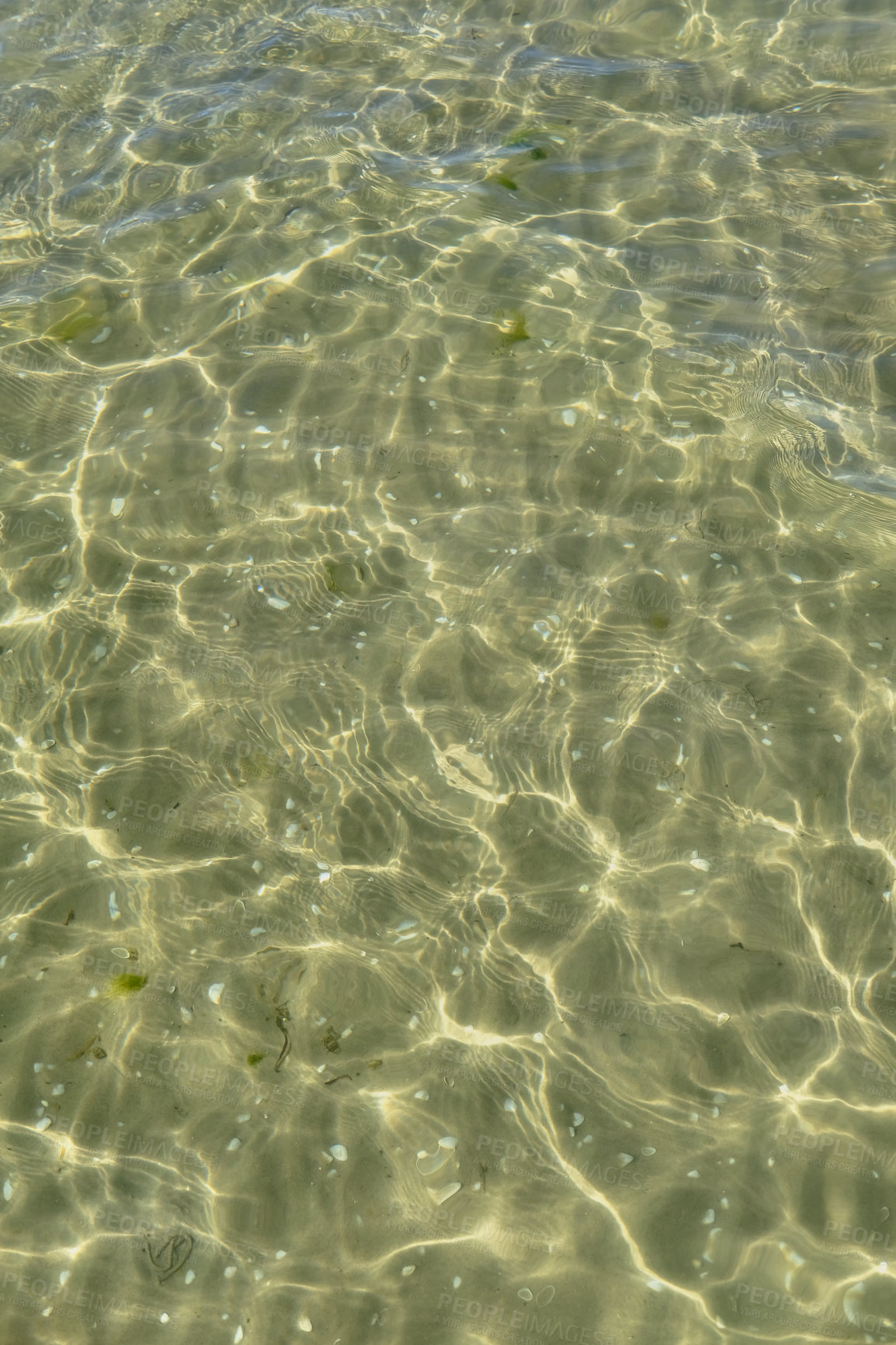 Buy stock photo Above view of sunlight reflecting off water at beach with copy space. Shallow waves and calm ripples on coastline on sunny day outside. Clear liquid refracting sun rays against summer background