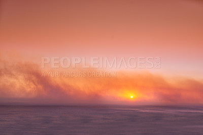 Buy stock photo Seascape of a beautiful golden sunset with copy space. Sun setting on the horizon of a calm ocean at dusk or twilight. The calm and tranquil ocean or sea in the evening with bright sky copyspace