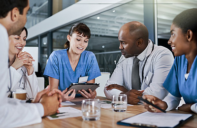 Buy stock photo Shot of a group of doctors having a meeting in a hospital