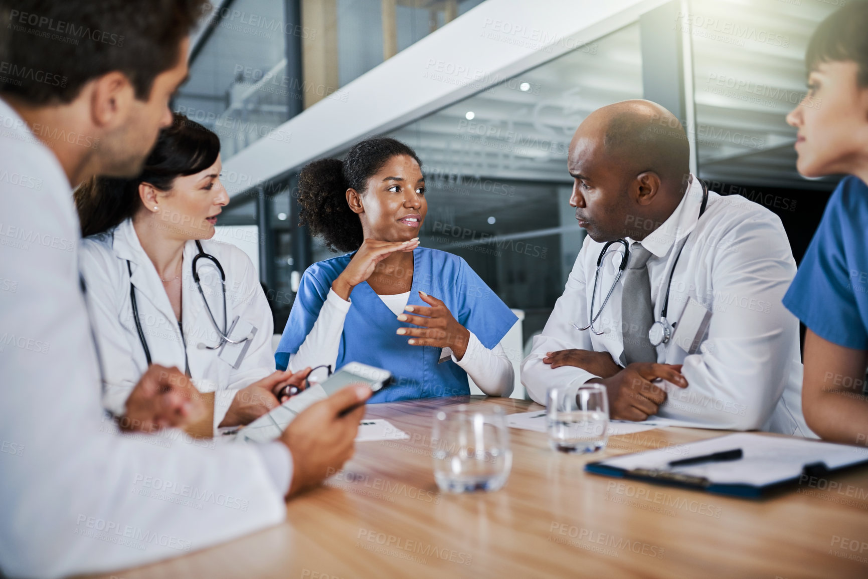 Buy stock photo Shot of a group of doctors having a meeting in a hospital