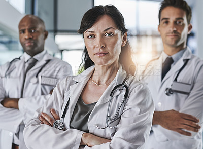 Buy stock photo Portrait of a team of confident doctors standing together in a hospital