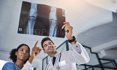 Buy stock photo Shot of two doctors discussing the results of an X-ray in a hospital