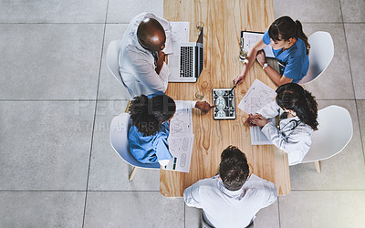 Buy stock photo Shot of a group of doctors having a meeting in a hospital