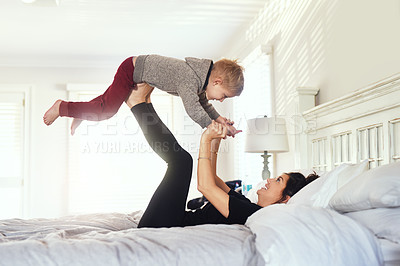 Buy stock photo Airplane, playing and mom with kid on bed for bonding, love and fun relationship in morning. Family, home and mother with young boy in bedroom for laughing, balance and relaxing together on weekend