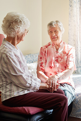 Buy stock photo Senior women, friends and holding hands in home, bed and smile for conversation, care and memory. People, retirement and happy in bedroom with chat, bonding and connection with love in Florida