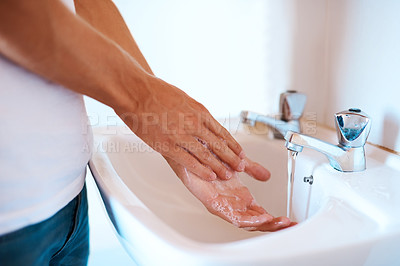 Buy stock photo Closeup shot of an unrecognizable man washing his hands at a basin