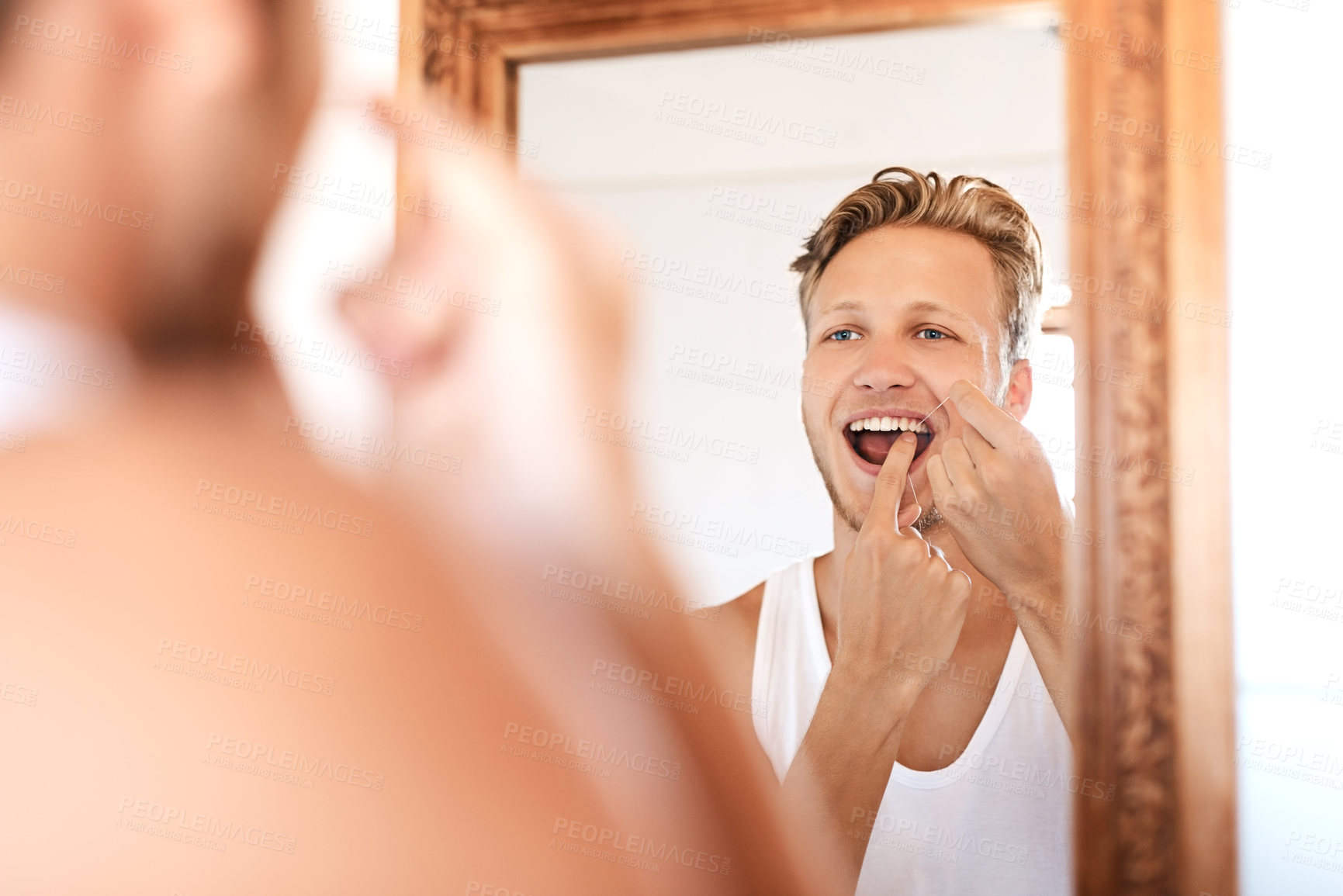 Buy stock photo Mirror, man and flossing in bathroom for healthy gums, teeth whitening or morning routine. Dental care, wellness and hands of person in reflection for fresh breath, remove plaque or hygiene in home