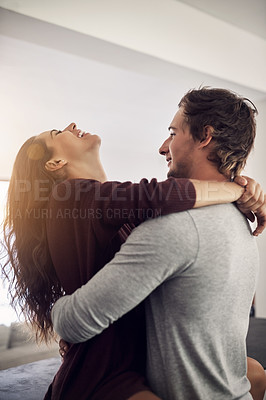 Buy stock photo Laughing couple, love and hug in apartment for care, quality time and bonding together for commitment to relationship. Happy young man, woman and hugging for romance, smile and relax with joy at home