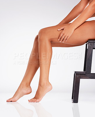 Buy stock photo Studio shot of an unrecognizable young woman's legs against a gray background