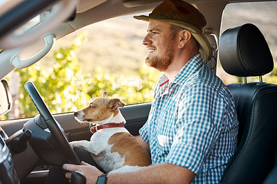 Buy stock photo Shot of a man and his dog driving in the countryside
