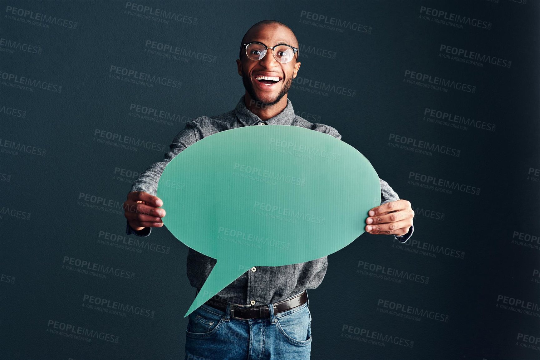 Buy stock photo Studio shot of a handsome young man holding a speech bubble