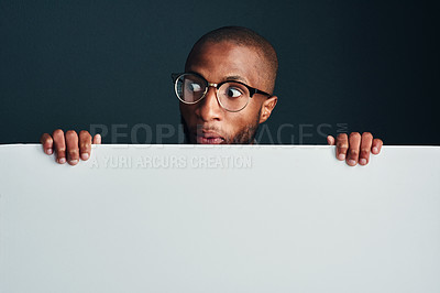 Buy stock photo Cropped shot of a man standing behind a blank placard