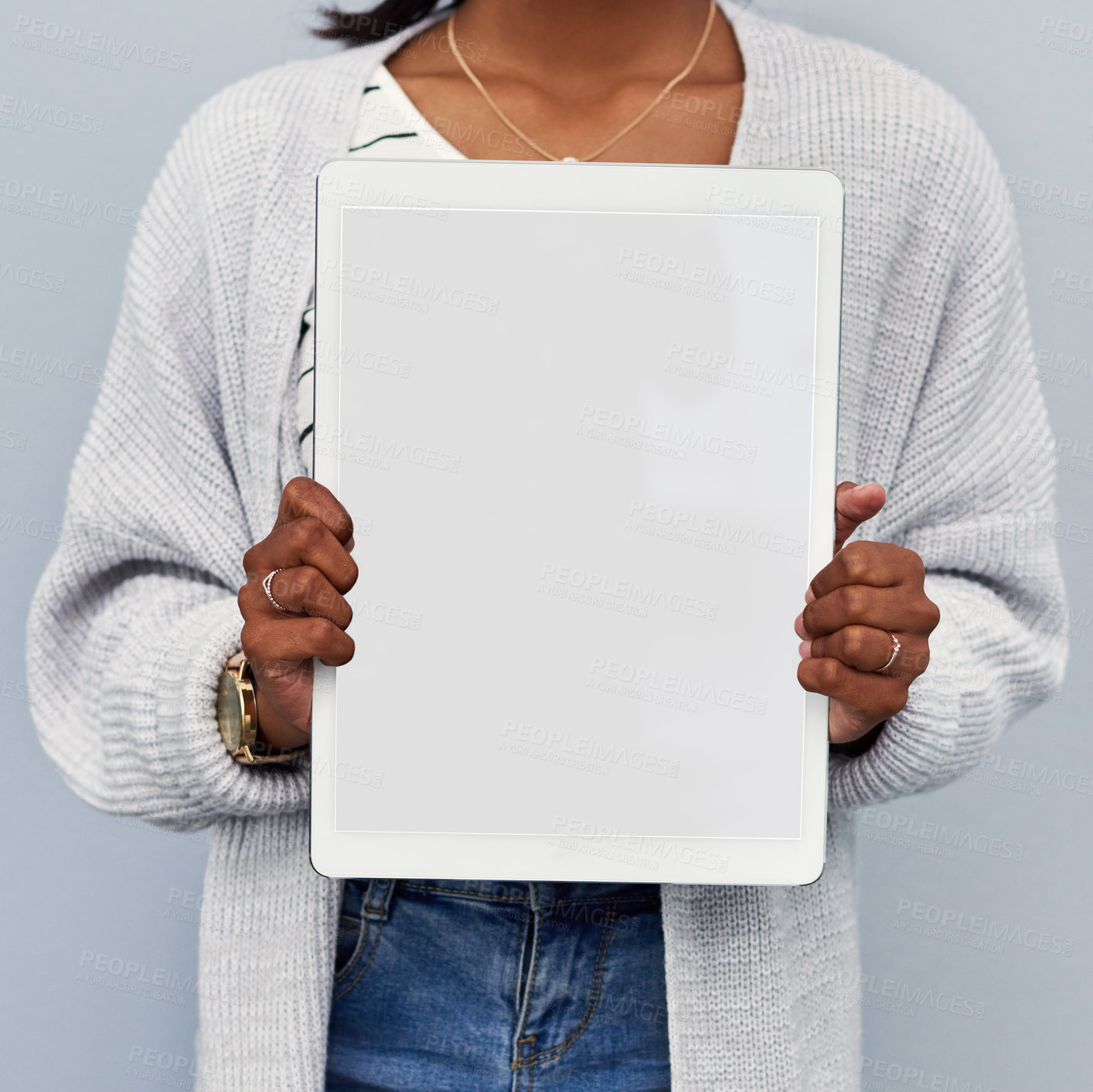 Buy stock photo Studio shot of an unrecognizable young woman holding a blank tablet against a grey background