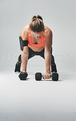 Buy stock photo Push up, fitness and woman with weights in studio for health, wellness and body training. Sports, energy and female athlete with equipment for arm workout or exercise isolated by gray background.