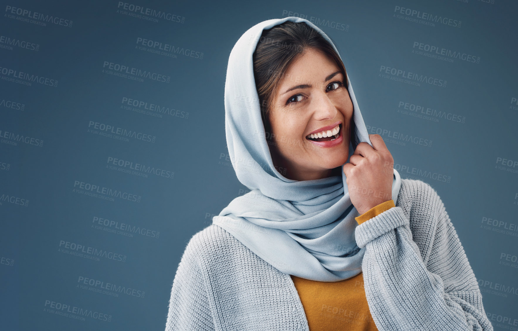 Buy stock photo Woman, studio and smile with hijab in portrait with happy for confidence for islamic culture. Faith, beauty and pride with blue background for arab people with religion, middle east and natural