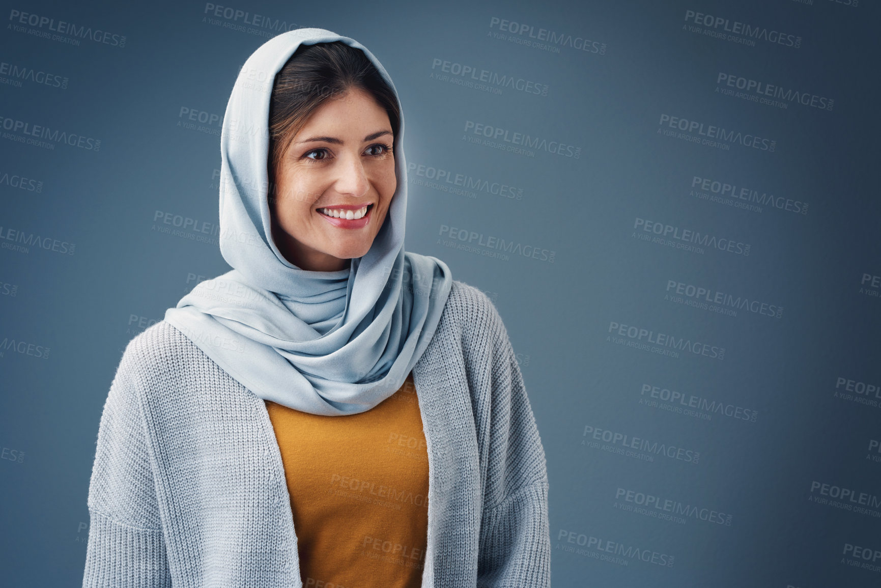 Buy stock photo Thinking, fashion and happy muslim woman with idea in studio isolated on blue background mockup space. Smile, dream and Islamic person in hijab for vision, inspiration or decision with casual clothes