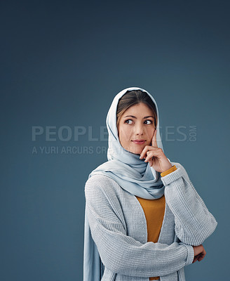 Buy stock photo Fashion, thinking and muslim woman with idea in studio isolated on a blue background mockup space. Serious, dream and Islamic person in hijab for vision, inspiration or decision with casual clothes