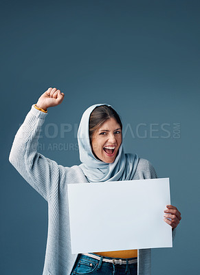 Buy stock photo Sign, protest and muslim woman in studio, mockup and empowerment on gray background. Product placement, sale and deal for retail advert with excited female model, Arabic and hijab with fist for power