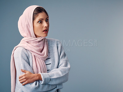Buy stock photo Shock, hijab and muslim woman with arms crossed in studio for surprise, wow or omg reaction on blue background. Islam, amazed and Arab person with wtf expression for gossip, fake news or announcement