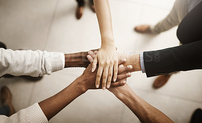 Buy stock photo Support, teamworking and joining hands together during team building session from above. Closeup of businesspeople doing stacked gesture to show collaboration in pursuit of goal or success in office
