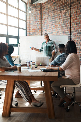 Buy stock photo Shot of a businessman giving a presentation in the boardroom