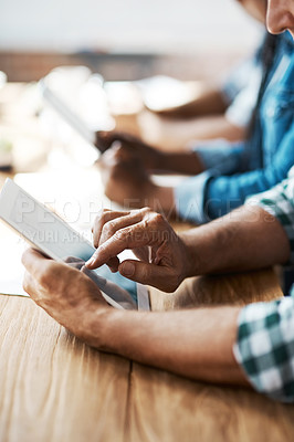 Buy stock photo Cropped shot of a businessman using a digital tablet during a boardroom meeting