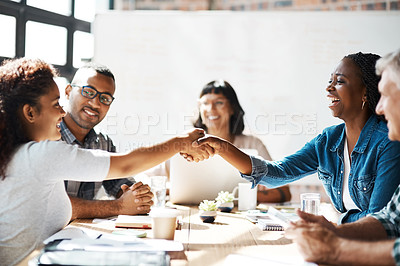 Buy stock photo Shot of two businesswomen  shaking hands during a meeting in the boardroom