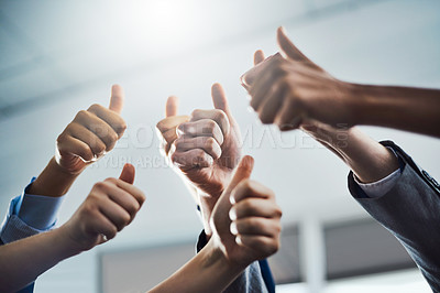 Buy stock photo Closeup shot of a group of businesspeople showing thumbs up in an office