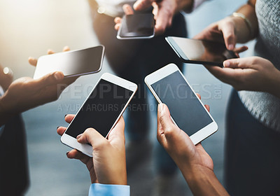 Buy stock photo Closeup shot of a group of businesspeople using their cellphones in synchronicity