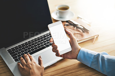 Buy stock photo Closeup shot of a businesswoman using a laptop and cellphone