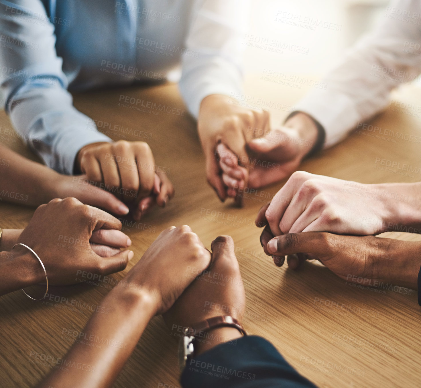 Buy stock photo Trust circle, therapy and people holding hands by a wood table at a group counseling or psychology session. Gratitude, spiritual and friends praying together for religion, community and connection.