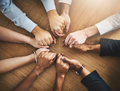 Buy stock photo Circle, solidarity and people holding hands by table at group counseling or therapy session. Gratitude, trust and friends with intimate moment for prayer together for religion, unity and connection.