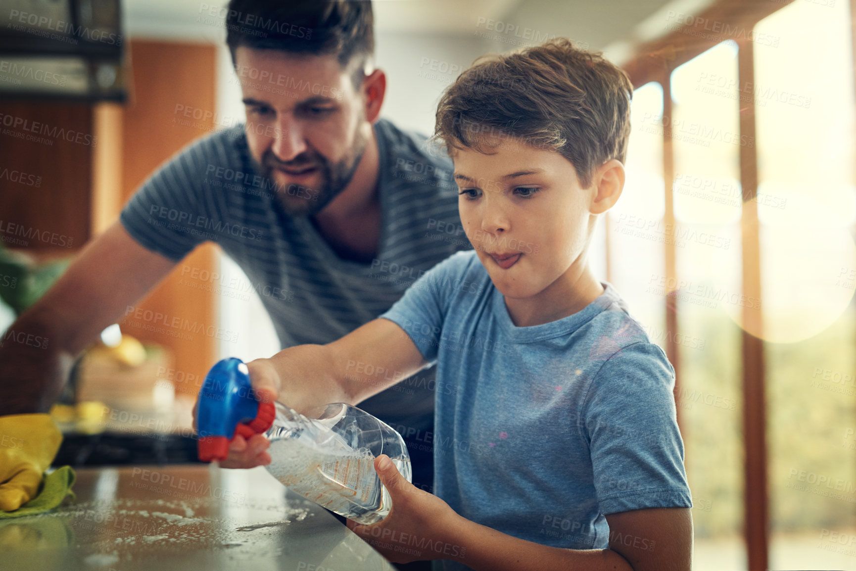 Buy stock photo Family, father and son cleaning the kitchen counter, development and growth at home. Parent, male child and dad with kid, support and teaching with chores, helping and learning with responsibility