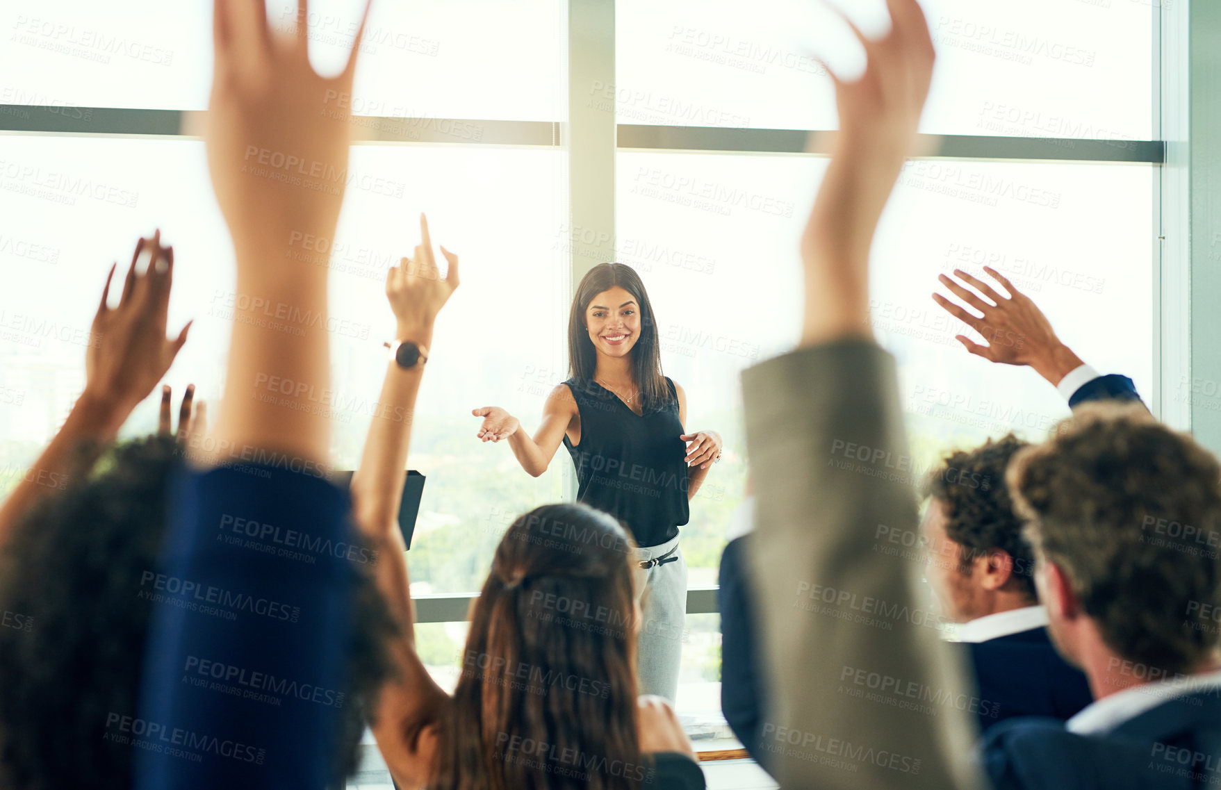 Buy stock photo Cropped shot of an attractive young businesswoman fielding questions from her colleagues during a seminar