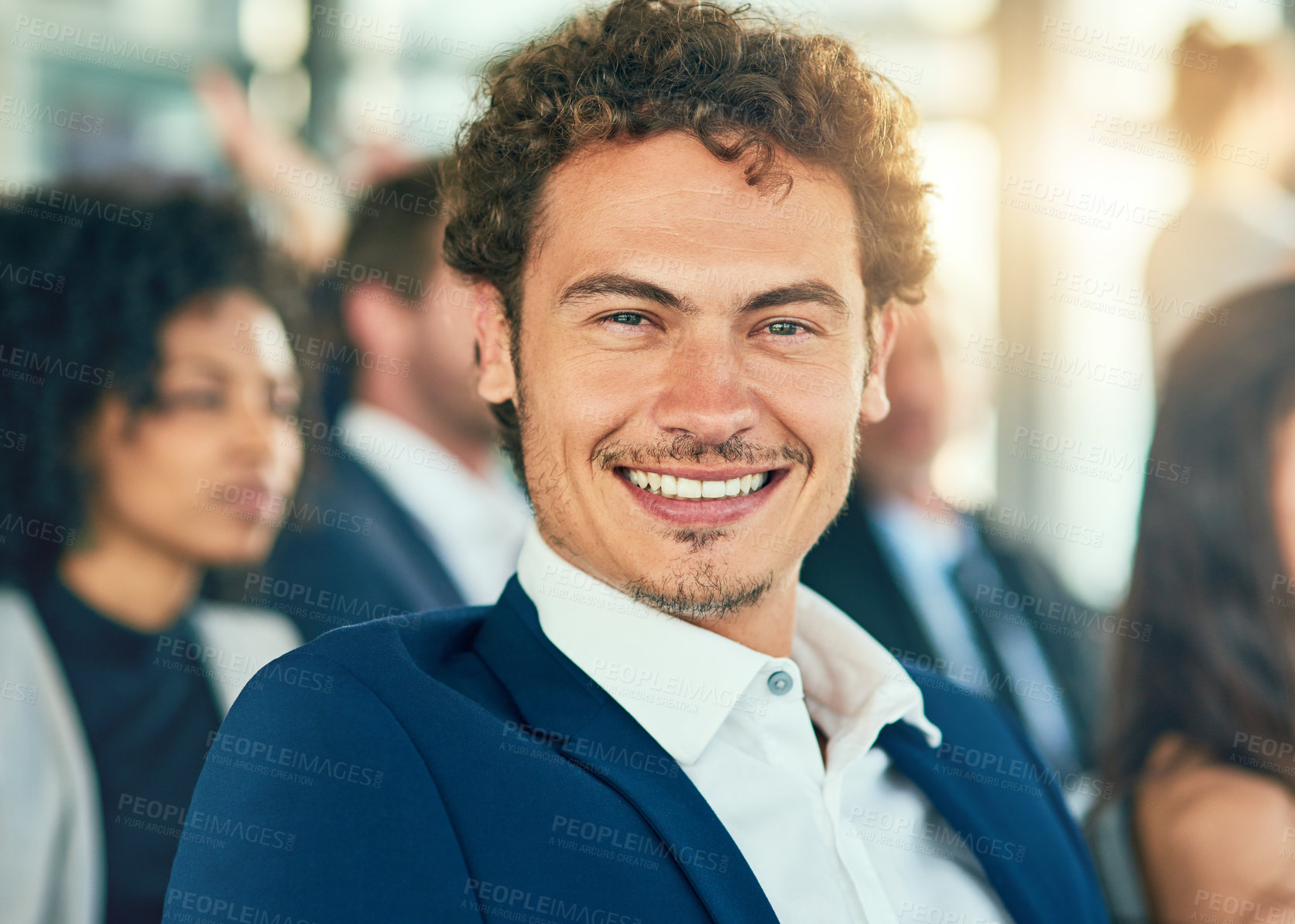 Buy stock photo Cropped portrait of a handsome young businessman sitting in a conference room during a seminar