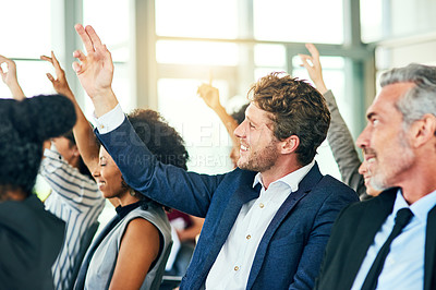 Buy stock photo Cropped shot of a group of businesspeople sitting with their hands raised in a conference room during a seminar