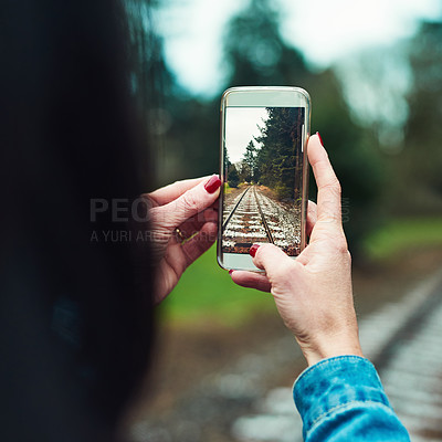 Buy stock photo Cropped shot of an unrecognizable woman taking a picture outdoors