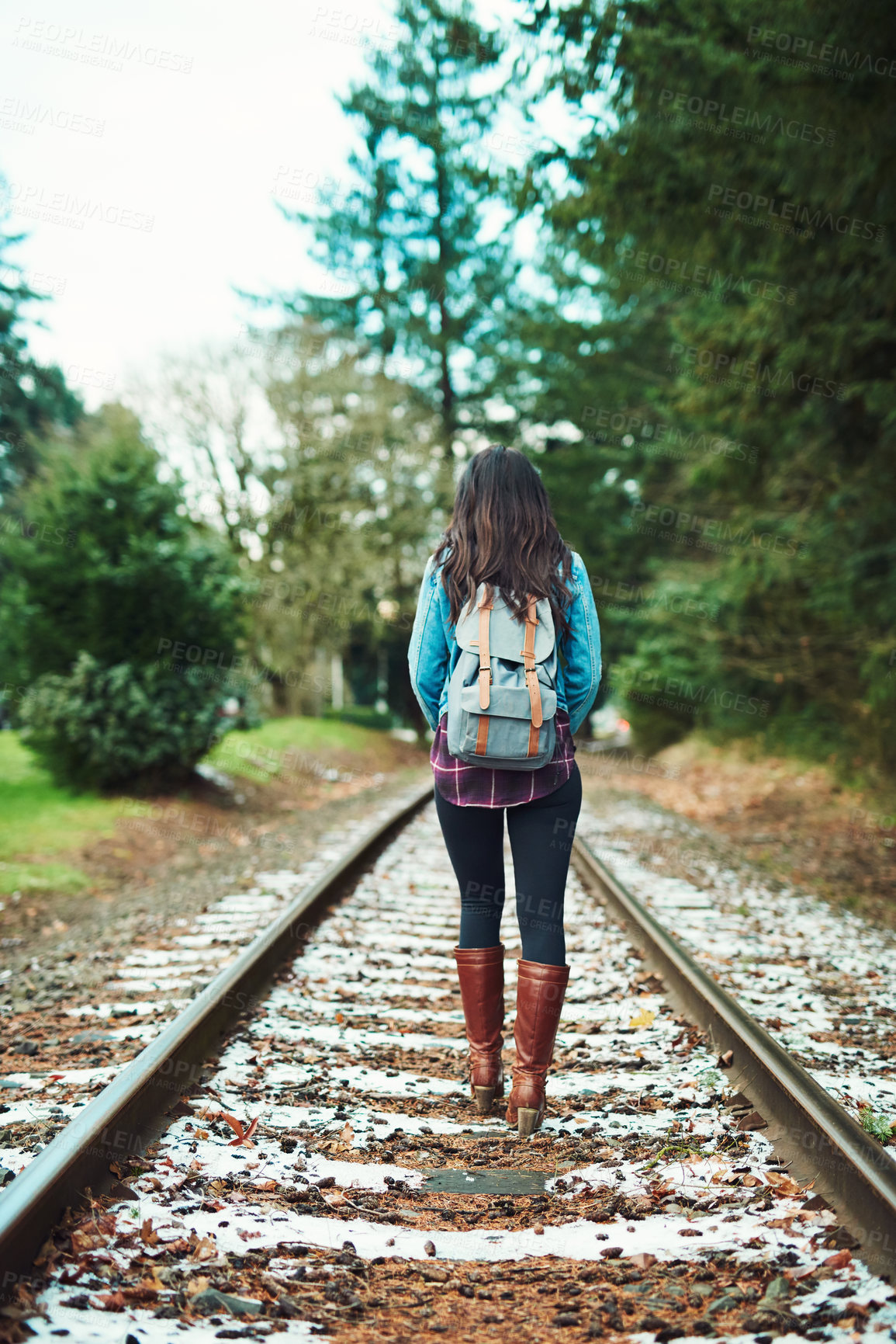 Buy stock photo Back, girl and walking on train track for travel, journey and adventure with backpack. Woman, freedom and trekking on railway lines for backpacking, danger and winter vacation on transport route