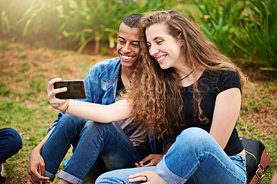 Buy stock photo Cropped shot of a young couple taking a selfie outside