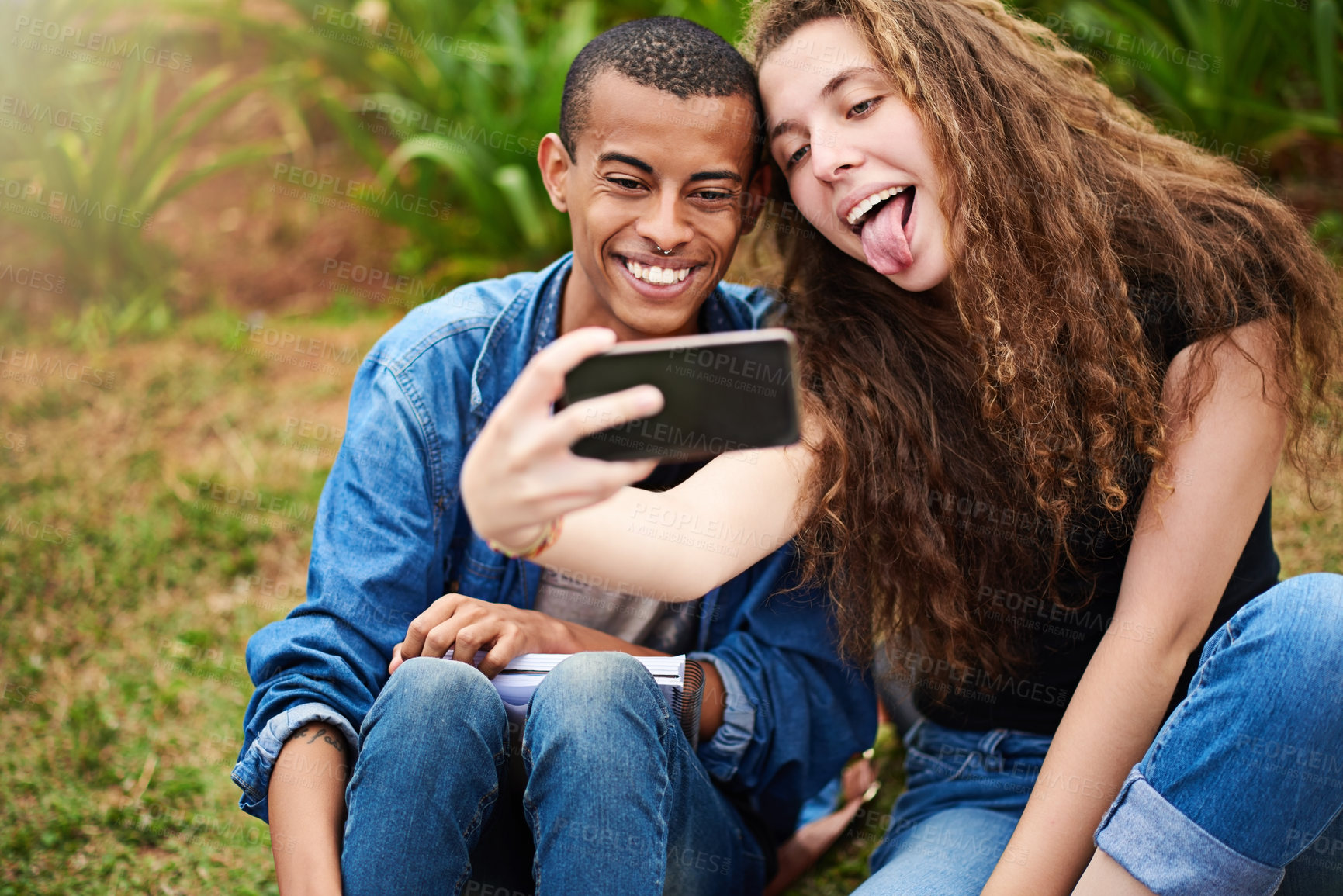 Buy stock photo Cropped shot of a young couple taking a selfie outside