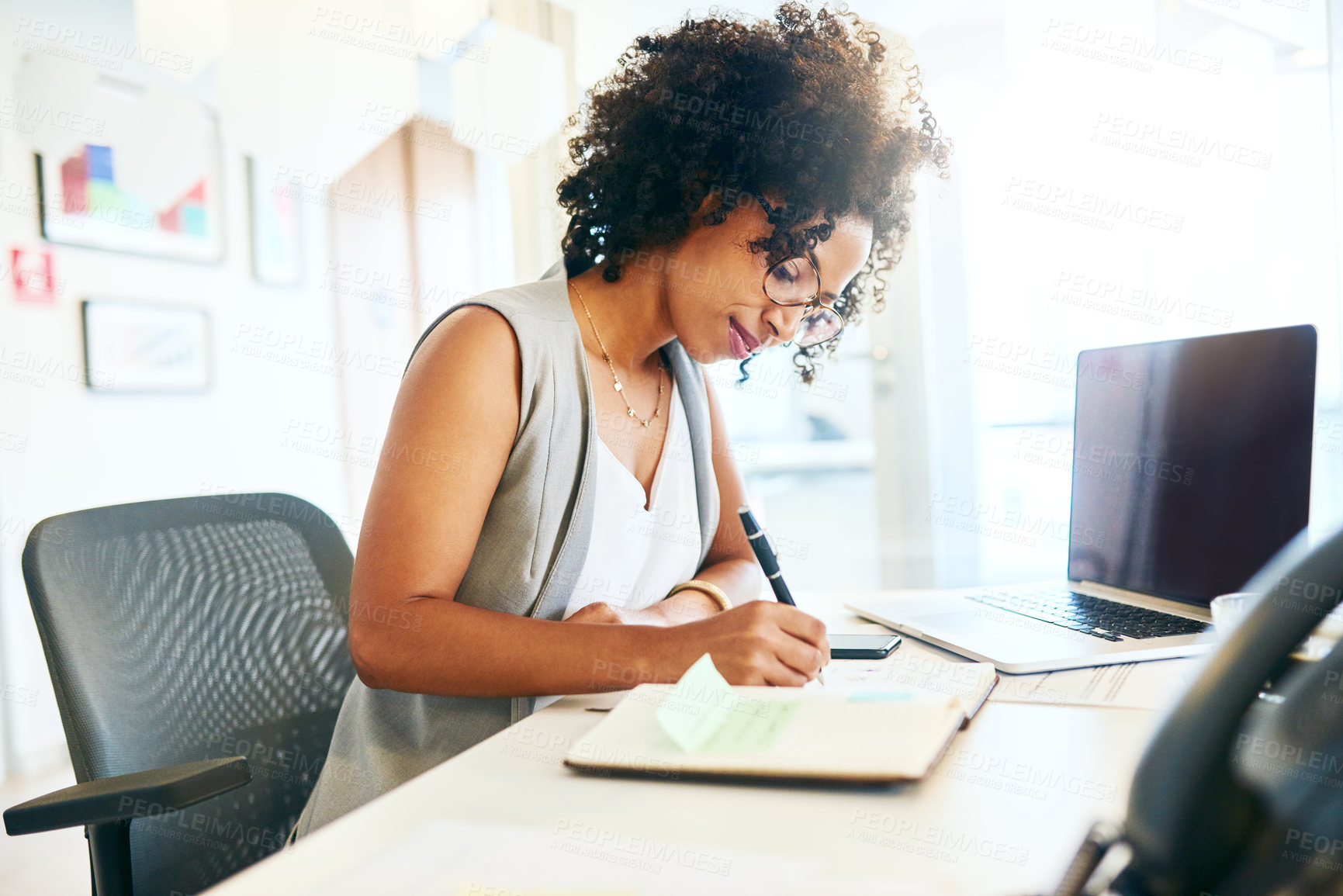 Buy stock photo Shot of a businesswoman working at her desk