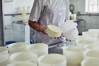 Buy stock photo Cheese, factory and hands of person, production and employee with apron, recipe and preparation with dairy. Process, gourmet and professional with equipment, fromager and work in kitchen or container