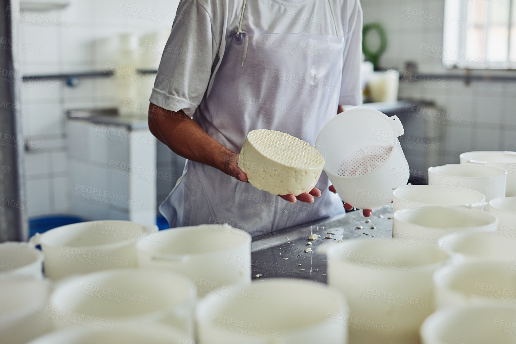 Buy stock photo Cheese, factory and hands of person, production and employee with apron, recipe and preparation with dairy. Process, gourmet and professional with equipment, fromager and work in kitchen or container