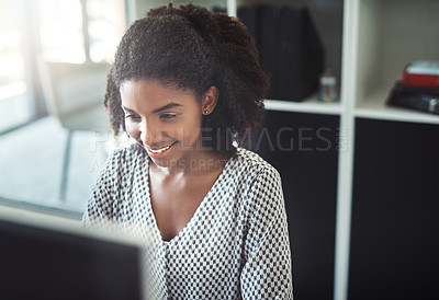 Buy stock photo Cropped shot of a young businesswoman working on her computer at her desk
