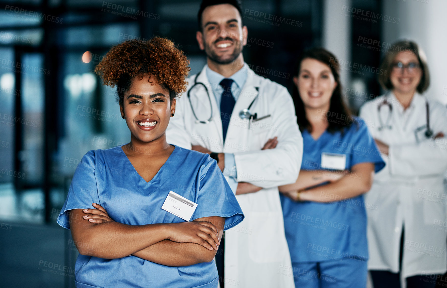 Buy stock photo Portrait of a team of confident doctors standing together in a hospital