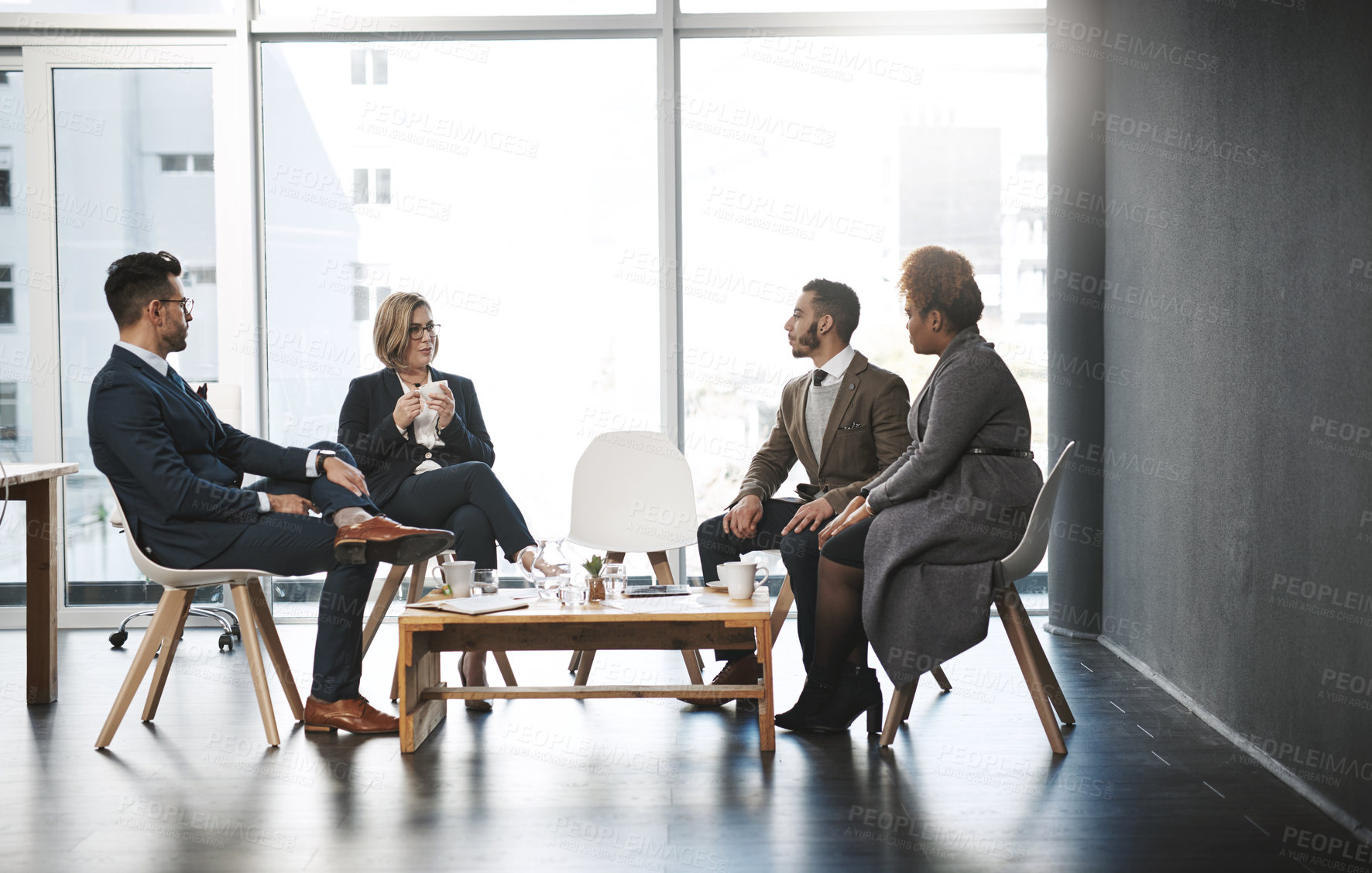 Buy stock photo Shot of a group of businesspeople having a meeting in an office