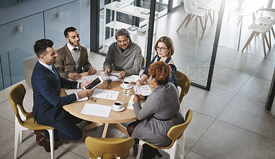 Buy stock photo Shot of a group of businesspeople having a meeting in an office