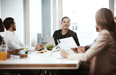 Buy stock photo Shot of a businessman having a meeting with his colleagues in a boardroom