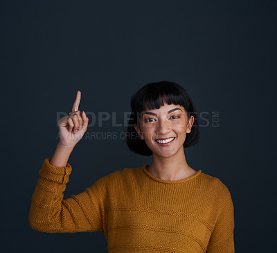 Buy stock photo Woman is pointing up, marketing and mockup space with portrait, smile and promo isolated on blue background. Young female person, happy ambassador and branding with advertising and show in studio