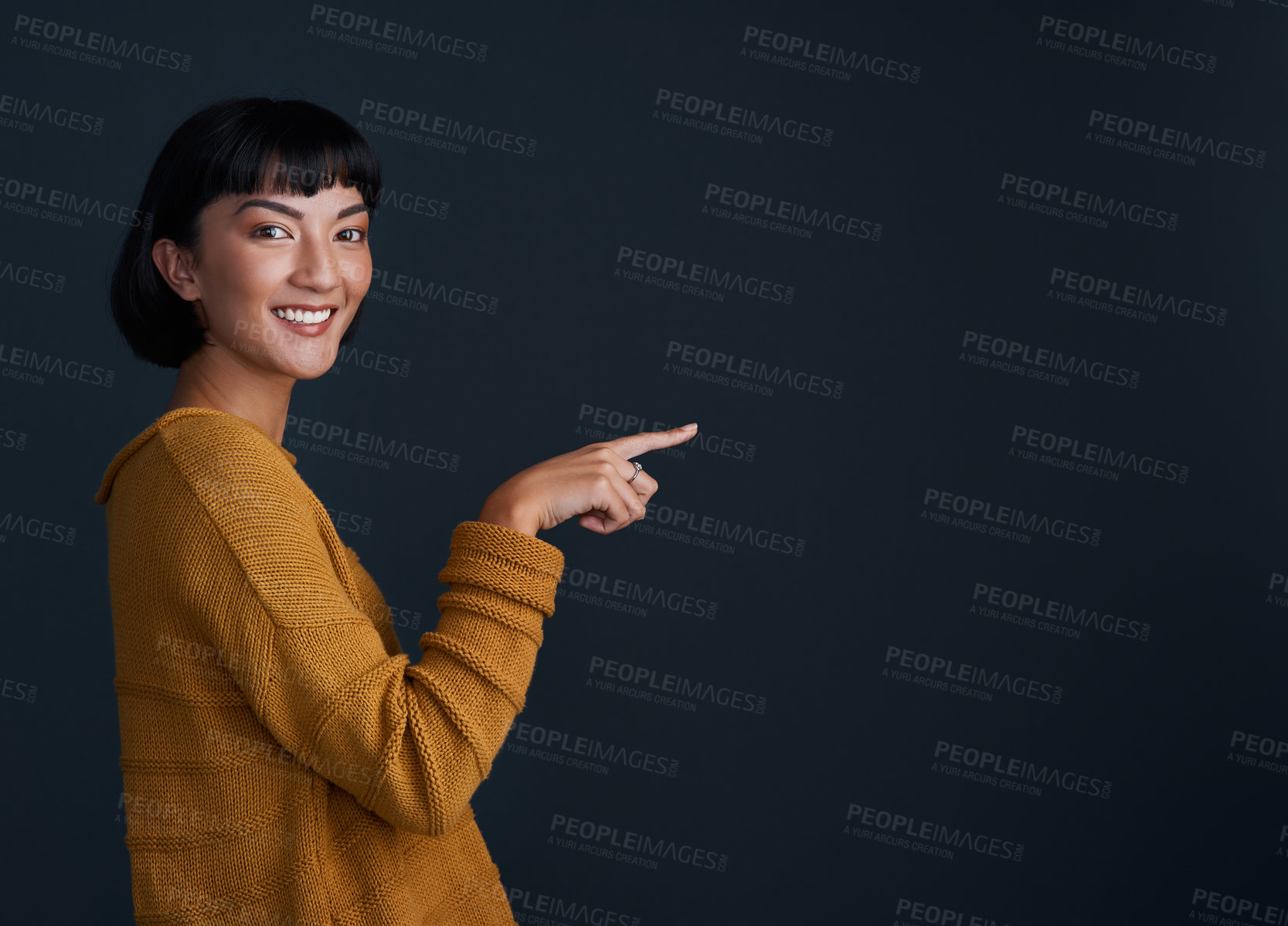 Buy stock photo Woman is pointing, advertising and mockup space with portrait, smile and promo isolated on dark background. Happy female person, ambassador and branding with marketing and presentation in studio